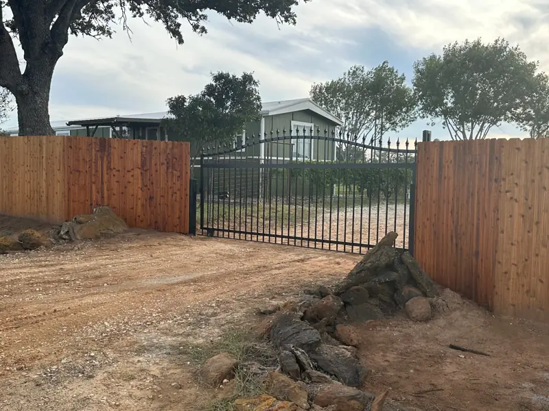 The drive gate from another angle, a house behind.