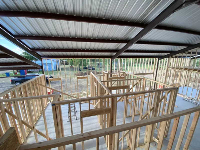 Interior walls framed in wood inside the steel frame.