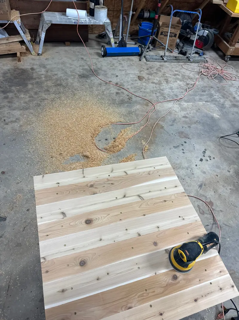 Tabletop being sanded.