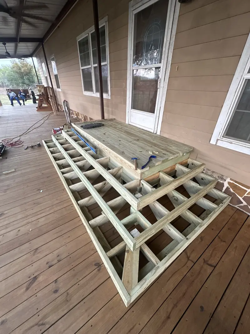 Step framing on the porch deck, seen from the side.