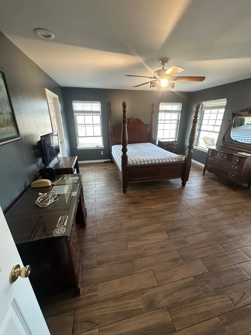 The finished bedroom in fresh gray paint, with the furniture back in place.