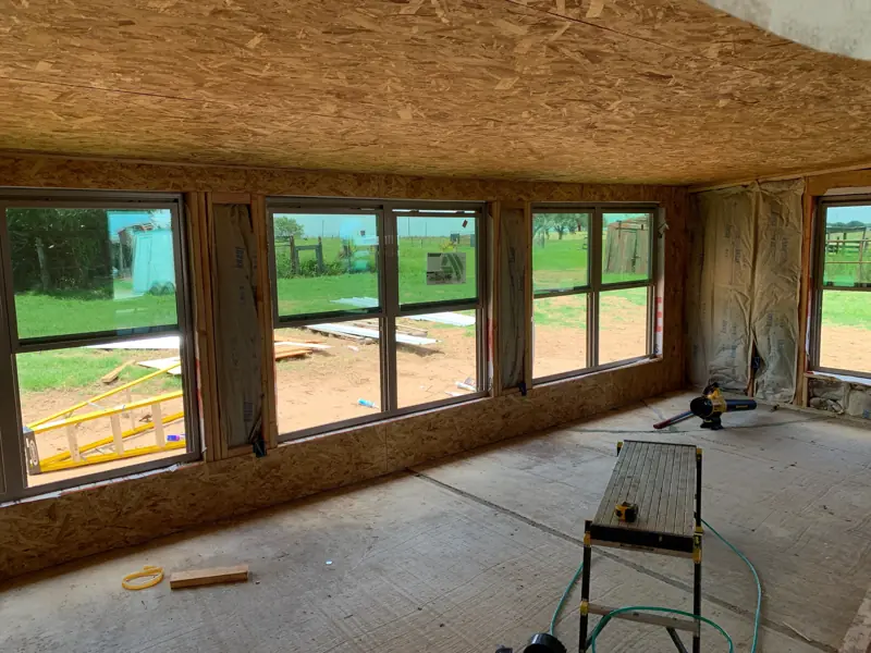 Inside the new room: windows set in a long row under a sheathed ceiling.