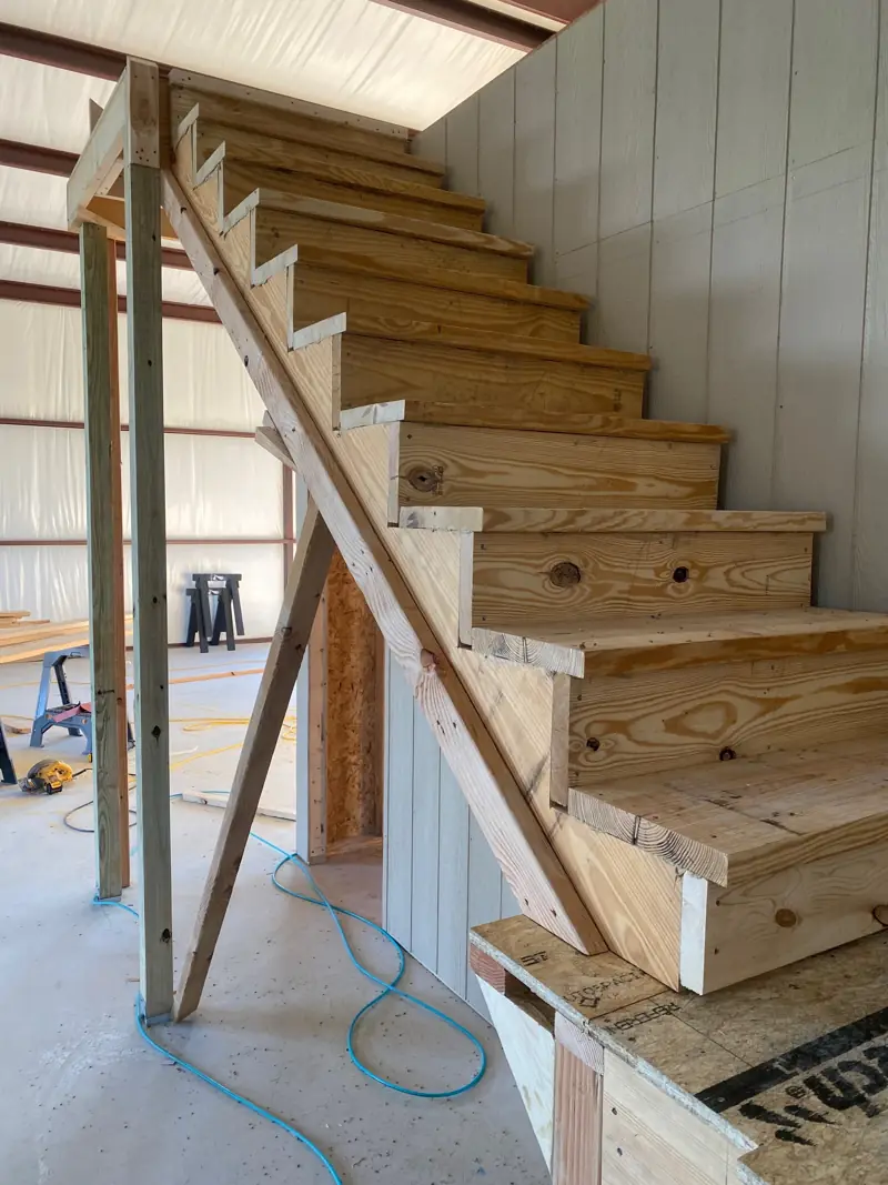 Wood stairs built up to the office loft.