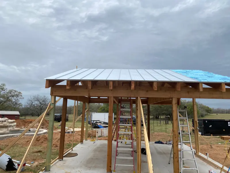 Metal roof going on over the cedar frame.