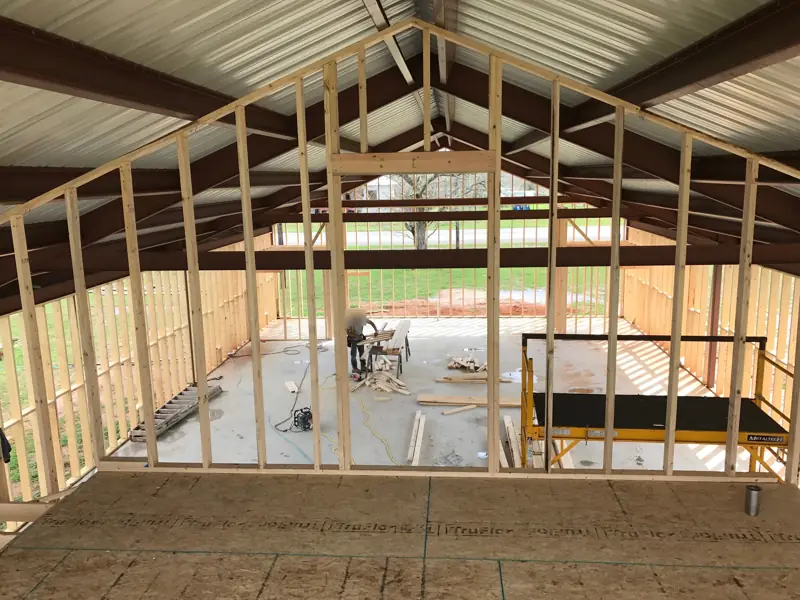 Framed gable wall seen from the new upper floor, looking down to the slab below.