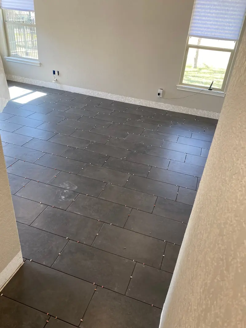 Large dark plank tile floor in an empty room.