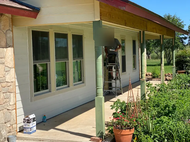New white lap siding along the porch.